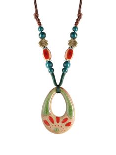 a necklace with an orange and green beaded pendant on a brown cord hanging from it's end