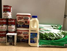 the ingredients for green beans and milk are on the counter next to cans of milk