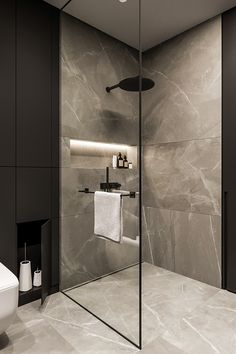 a modern bathroom with marble walls and flooring