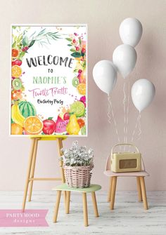 a welcome sign next to some balloons and a table with a basket full of flowers