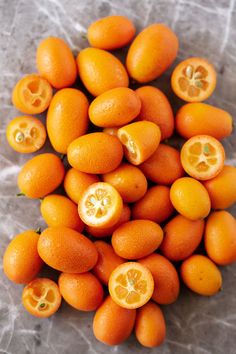 a pile of oranges sitting on top of a table