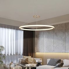 a living room filled with furniture and a round light hanging from the ceiling above it