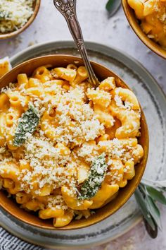 a bowl filled with pasta and topped with parmesan cheese