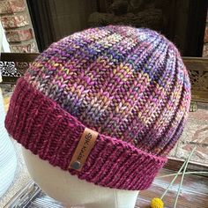 a knitted hat sitting on top of a white mannequin's head