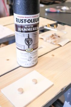 a can of rustoleum sitting on top of a table next to some wood