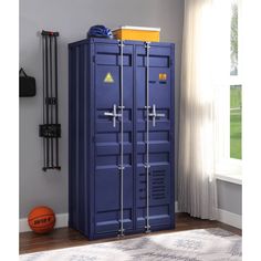 a large blue locker sitting in the corner of a room next to a basketball ball