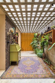 a room with plants and rugs in it