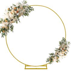 a circular gold frame with white flowers and greenery around it, on a white background