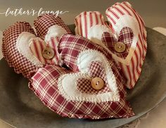 red and white plaid heart shaped pillows on a plate with buttoned buttons in the shape of hearts