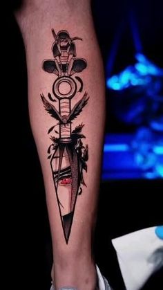 a man's leg with a tattoo on it and an arrow in the center