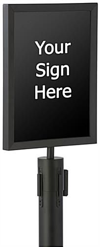 a large screen tv on top of a black stand with a white sign above it that says your sign here