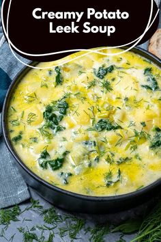 creamy potato and leek soup in a black bowl on a blue cloth with bread