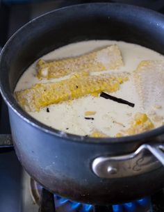 corn on the cob being cooked in a pot