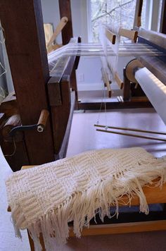 an old weaving machine is being worked on