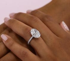 a woman's hand with a diamond ring on it