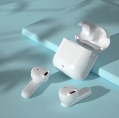 an apple airpods sitting on top of a table next to another pair of ear buds