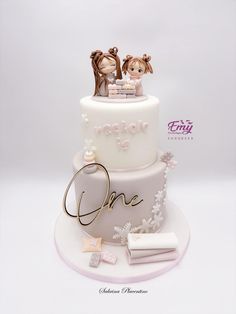 a wedding cake with two bride and groom figurines on top