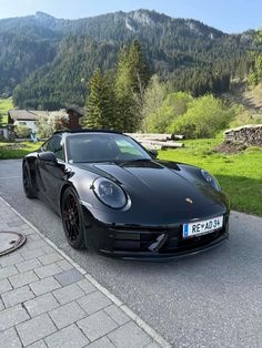 a black sports car parked on the side of a road