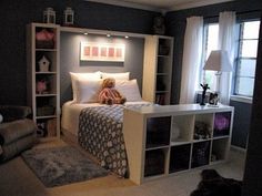 a teddy bear sitting on top of a bed in a bedroom