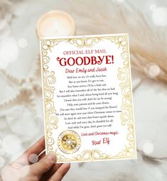 someone holding up a greeting card with the words goodbye written in gold and red on it