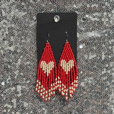 Discover the beauty of handcrafted elegance with these fringe beaded earrings. Featuring these lightweight earrings add a touch of boho charm to any outfit. Perfect for casual wear or special occasions, they are made with love using high-quality beads and durable hooks for long-lasting style. Whether you're looking for a unique gift or a statement piece for yourself, these earrings are the perfect accessory. Seed Bead Heart, Fringe Beaded Earrings, Bead Heart, Lightweight Earrings, Light Weight Earrings, Fringe Earrings, Seed Bead, Earring Gifts, Statement Jewelry