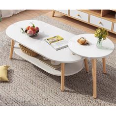 two white tables sitting on top of a carpeted floor