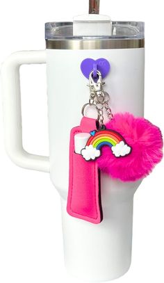 a cup with a keychain attached to it and a rainbow on the handle