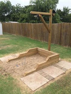 a wooden structure sitting in the middle of a yard