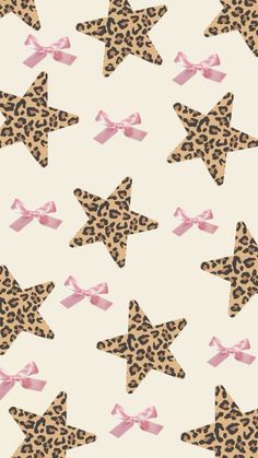 an animal print wallpaper with pink bows and leopard stars on it's side