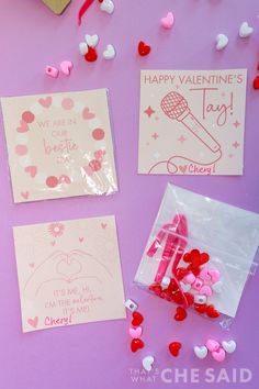 valentine's day cards and confetti on a purple background