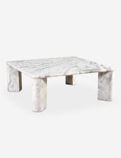 a white marble coffee table with two legs and a square shaped design on the top