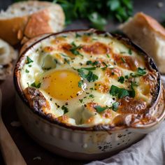 an egg in a bowl with bread and parsley on the side for garnish