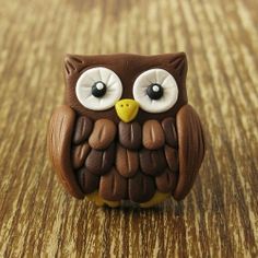 an owl figurine sitting on top of a wooden table