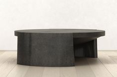 a concrete coffee table sitting on top of a hard wood floor