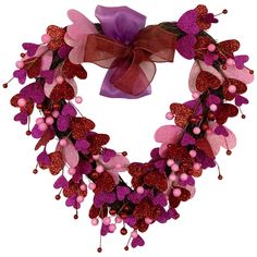 a heart shaped wreath with purple and pink flowers