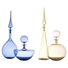 three different colored vases sitting next to each other in front of a white background