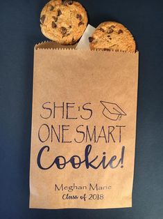 there is a bag that has two cookies in it and the label says she's one smart cookie