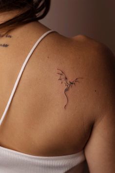 a woman with a tattoo on her shoulder