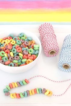 some sprinkles are sitting on a tray next to a bowl of cereal