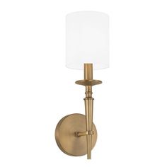 a gold wall light with a white shade on the top and bottom half of it