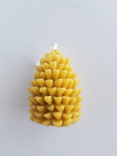 a small pine cone sitting on top of a white table