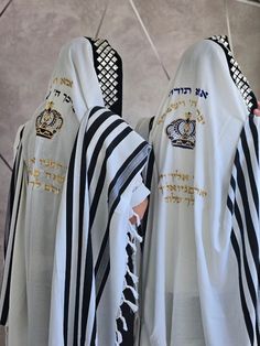 100 % wool tallit made of a cross-stitch fabric that prevents the tallit from slipping during prayer. a unique beautiful design that includes a crown in two colors and the ''Birkat kohanim''. At the top of the tallit embroidered a beautiful head crown with stones on a black velvet fabric base. Thanks to the unique weaving, the tallit is lightweight and airy. You can embroider on the tallit your name. MATERIALS:  The tallit is made of 100% wool. SIZES: 60- Suitable for 1.65-1.80 cm 70- Suitable for 1/75-1.95 cm PRODUCTION TIMES: We are doing our best to bring you the product as soon as possible, without compromising the quality . Usually, the preparation of the product takes between 1-2 weeks SHIPPING: The shipment is  arrives between 6-10 days. HOW TO ORDER: When placing your order, please Jewish Prayer, Head Crown, Black Velvet Fabric, Prayer Shawl, Jewish Gifts, Cross Stitch Fabric, Velvet Fabric, Clothing Items, Beautiful Design