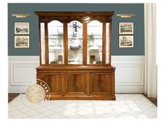 a wooden china cabinet sitting in the corner of a room