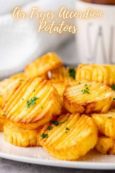 some fried potatoes on a white plate with the words air fryer accordion potatoes