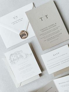 the wedding stationery is laid out on top of each other