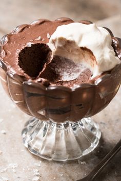 someone is scooping ice cream into a chocolate dessert