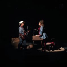 two people are playing instruments in the dark