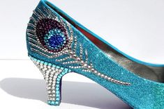 The unforgettable and unmistakable crystal peacock feather that catches attention immediately when it is seen on these elegant shoes. The aqua blue ombre colored glitter sets off the top of the heels. Eggplant purple glitter on the soles and last but not least aqua and clear Swarovski crystals to accent the heels. You Peacock Shoes, Heels 3 Inch, Peter Piper, Converse Wedding, Feather Heels, Shoes Board, Wedding Converse, Glamour Nails, Peacock Art