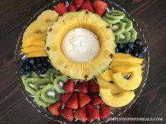 a platter filled with sliced fruit and whipped cream