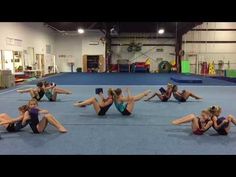 a group of women sitting on the ground doing exercises